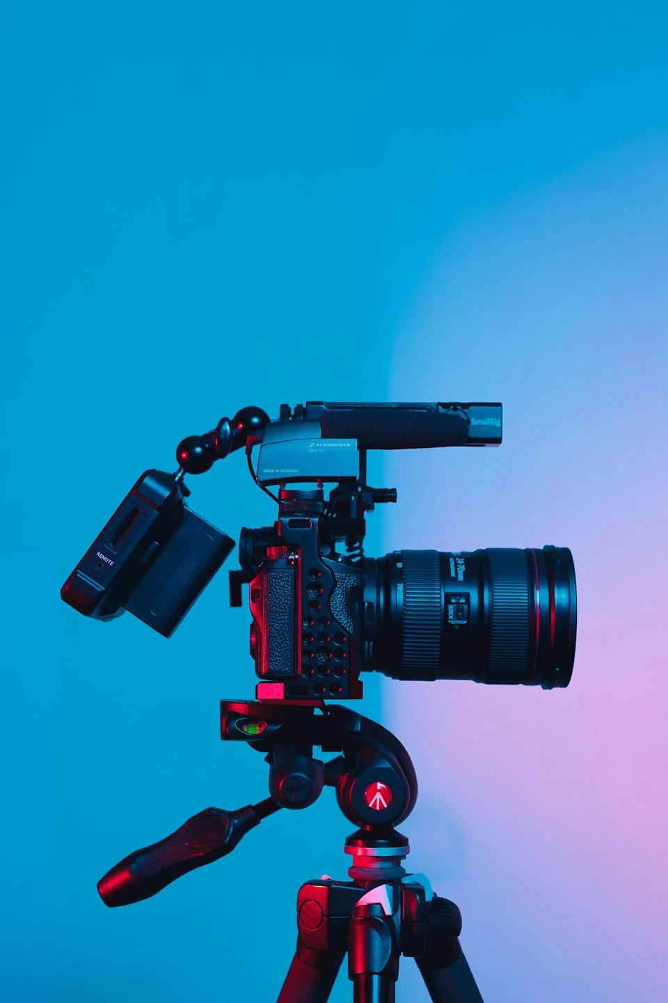Professional videography camera on tripod with microphone and monitor.