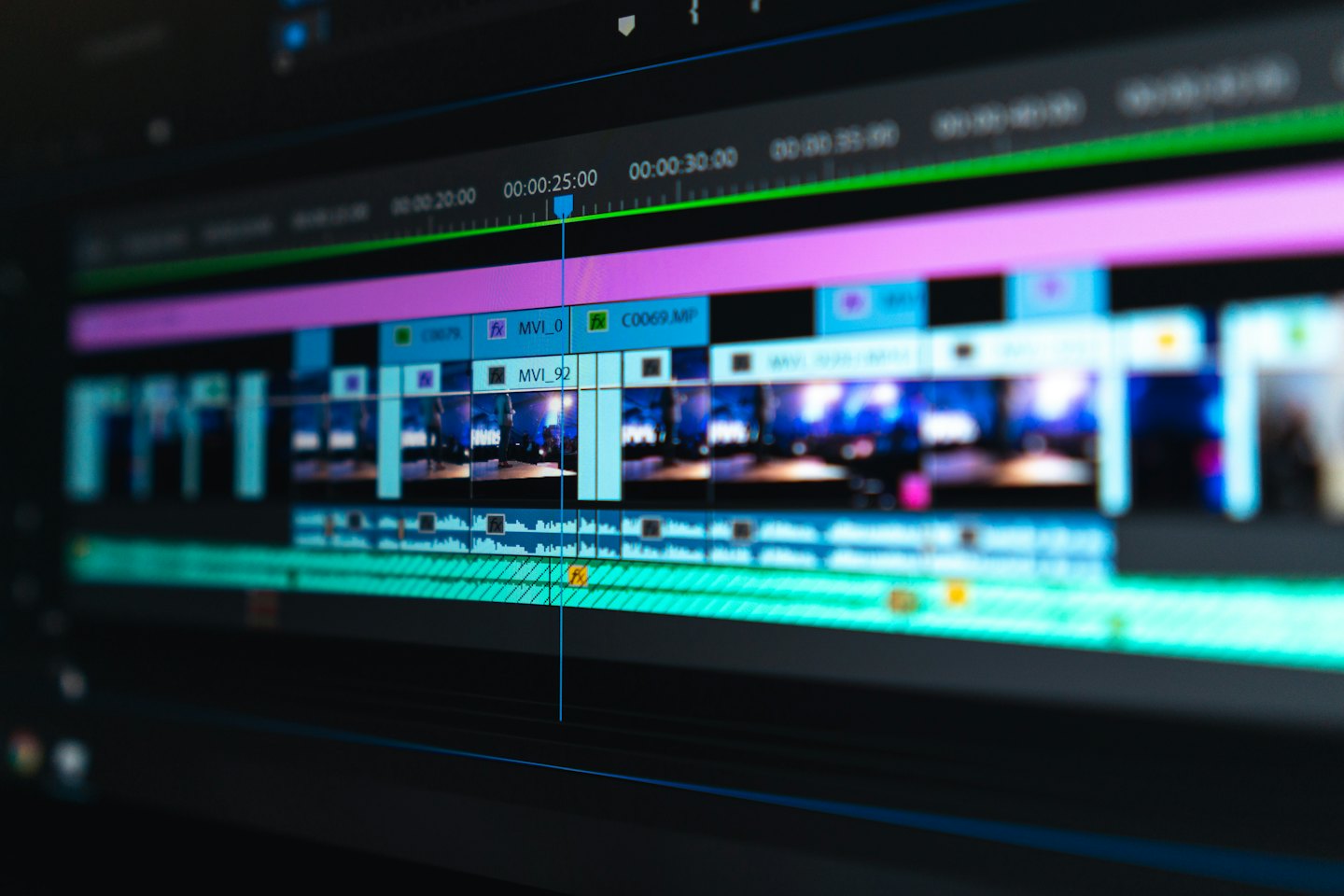 Computer screen shows video editing software with colorful timelines.